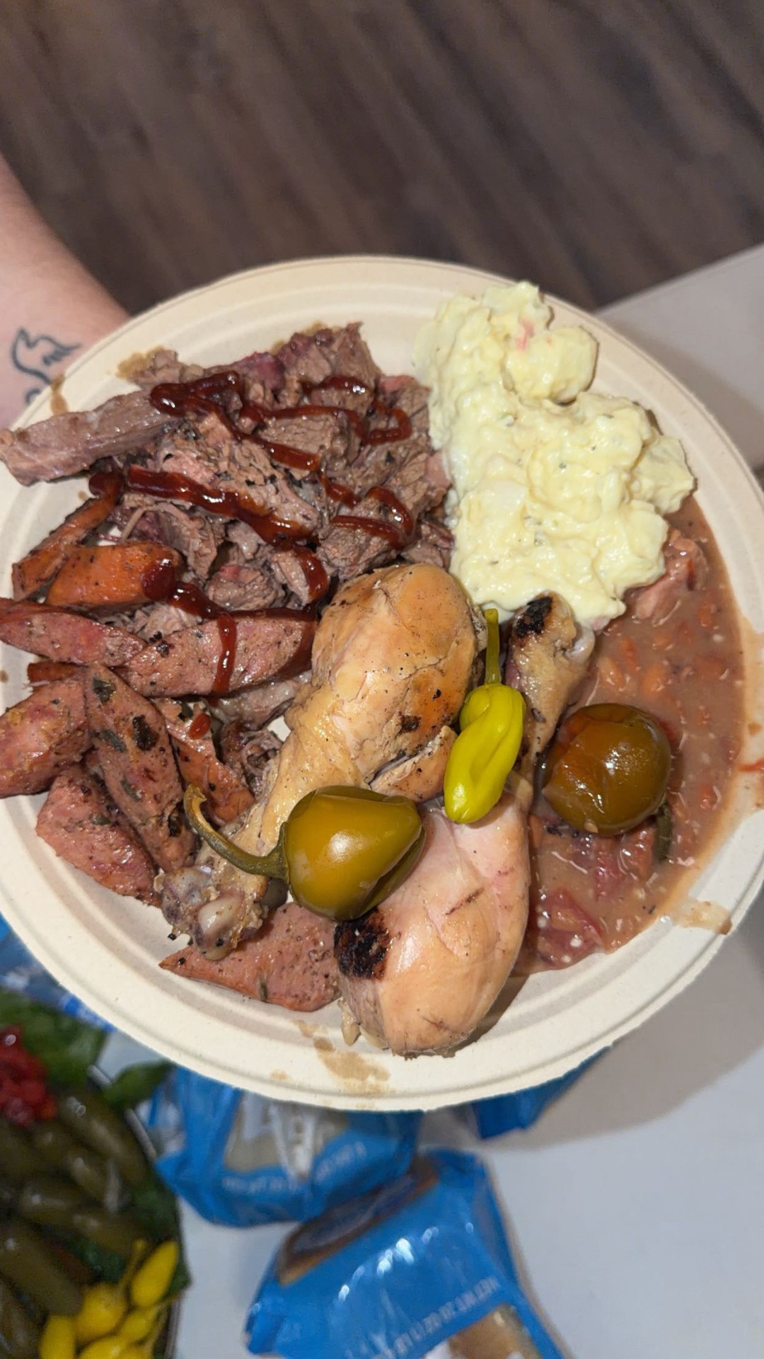 Big E BBQ catering plate with brisket, sausage, smoked chicken, potato salad and pinto beans